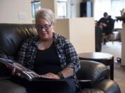 Angela Daniels looks at a photo of her son, Damian Daniel Rodriguez, 23, from a mud race they ran together a few months before his schizophrenia diagnosis, at her Vancouver home.