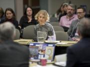 Jerri Clark, center, shares her son’s story and a vision board for a proposed behavioral health crisis triage and stabilization center in Vancouver on Jan. 6, 2017, with members of the Southwest Washington Regional Health Care Advisory Committee at the Clark County Public Service Center.