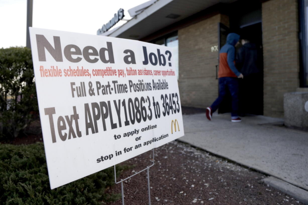 In this Jan. 3, 2019, photo customers enter a McDonald’s restaurant near an employment sign in Atlantic Highlands, N.J. On Wednesday, Jan. 30, payroll processor ADP reports how many jobs private employers added in January.