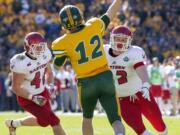 North Dakota State quarterback Easton Stick (12) throws a pass in front of the rush of Eastern Washington linebacker Ketner Kupp (40) and defensive lineman Nick Foerstel (92) during the first half of the FCS championship NCAA college football game, Saturday, Jan. 5, 2019, in Frisco, Texas.