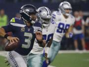 Seattle Seahawks quarterback Russell Wilson (3) runs out of the pocket against the Dallas Cowboys during the first half of the NFC wild-card NFL football game in Arlington, Texas, Saturday, Jan. 5, 2019.