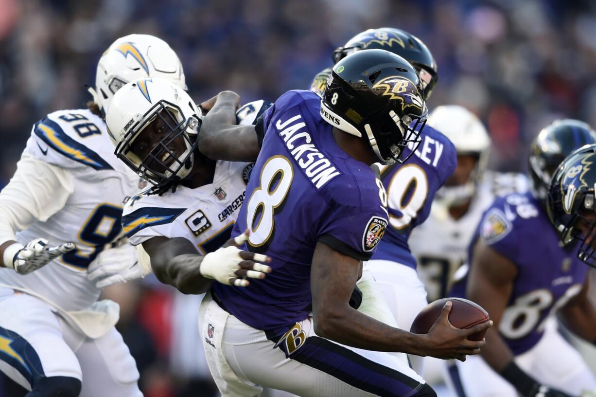 Baltimore Ravens quarterback Lamar Jackson (8) is sacked by Los Angeles Chargers defensive end Melvin Ingram in the second half of an NFL wild card playoff football game, Sunday, Jan. 6, 2019, in Baltimore.