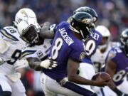 Baltimore Ravens quarterback Lamar Jackson (8) is sacked by Los Angeles Chargers defensive end Melvin Ingram in the second half of an NFL wild card playoff football game, Sunday, Jan. 6, 2019, in Baltimore.