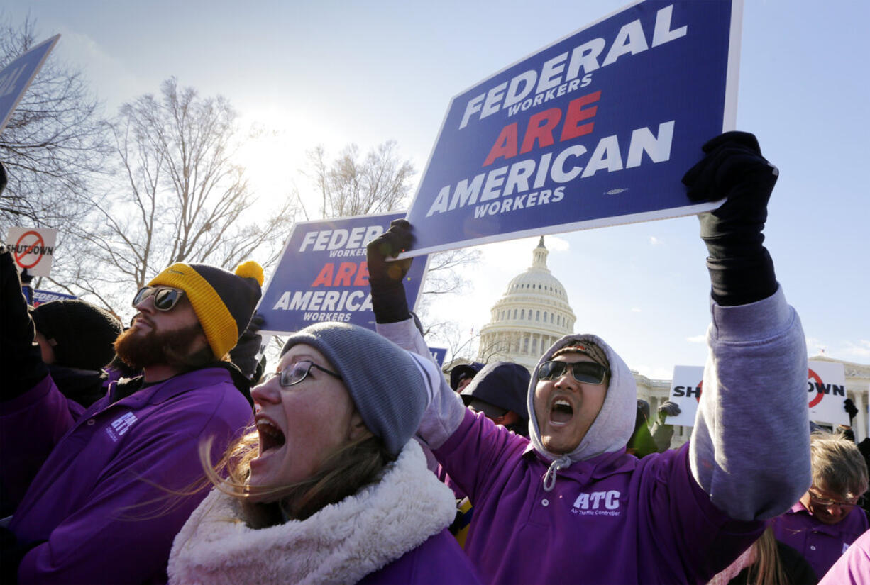 On the 20th day of a partial government shutdown, federal employees rally at the Capitol to protest the impasse between Congress and President Donald Trump over his demand to fund a U.S.-Mexico border wall, in Washington, Thursday,  Jan. 10, 2019. (AP Photo/J.