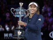 Japan's Naomi Osaka poses with her trophy after defeating Petra Kvitova of the Czech Republic in the women's singles final at the Australian Open tennis championships in Melbourne, Australia, Saturday, Jan. 26, 2019.