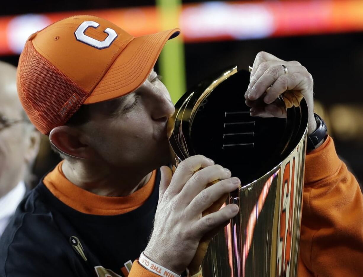 Clemson head coach Dabo Swinney kisses the championship trophy after the NCAA college football playoff championship game against Alabama, Monday, Jan. 7, 2019, in Santa Clara, Calif. Clemson beat Alabama 44-16. (AP Photo/David J.