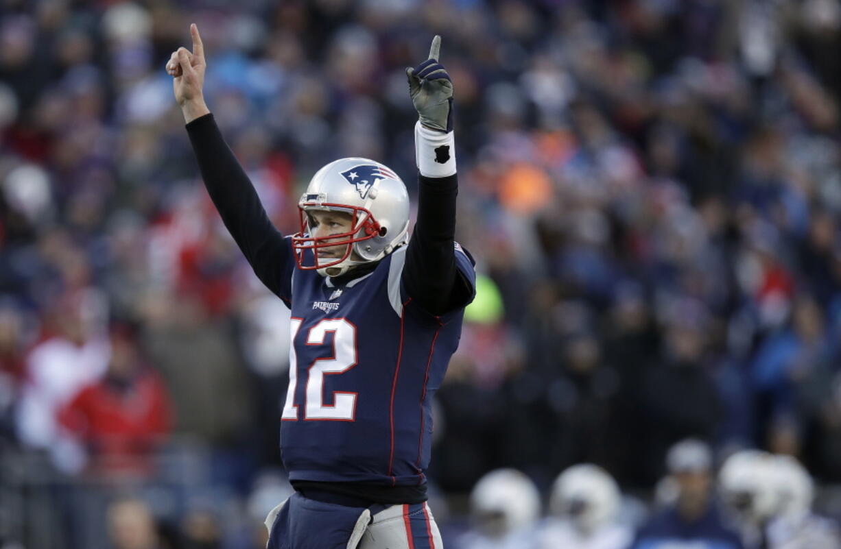 New England Patriots quarterback Tom Brady celebrates a touchdown run by running back Sony Michel during the first half of an NFL divisional playoff football game against the Los Angeles Chargers, Sunday, Jan. 13, 2019, in Foxborough, Mass.