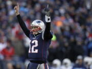 New England Patriots quarterback Tom Brady celebrates a touchdown run by running back Sony Michel during the first half of an NFL divisional playoff football game against the Los Angeles Chargers, Sunday, Jan. 13, 2019, in Foxborough, Mass.