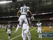 Philadelphia Eagles wide receiver Golden Tate (19) celebrates his touchdown reception with offensive tackle Lane Johnson (65) during the second half of an NFL wild-card playoff football game against the Chicago Bears Sunday, Jan. 6, 2019, in Chicago. (AP Photo/Nam Y.