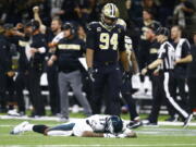 Philadelphia Eagles wide receiver Alshon Jeffery (17) lies on the turf in front of New Orleans Saints defensive end Cameron Jordan (94) after the Saints intercepted a pass in the second half of an NFL divisional playoff football game in New Orleans, Sunday, Jan. 13, 2019. The Saints won 20-14.