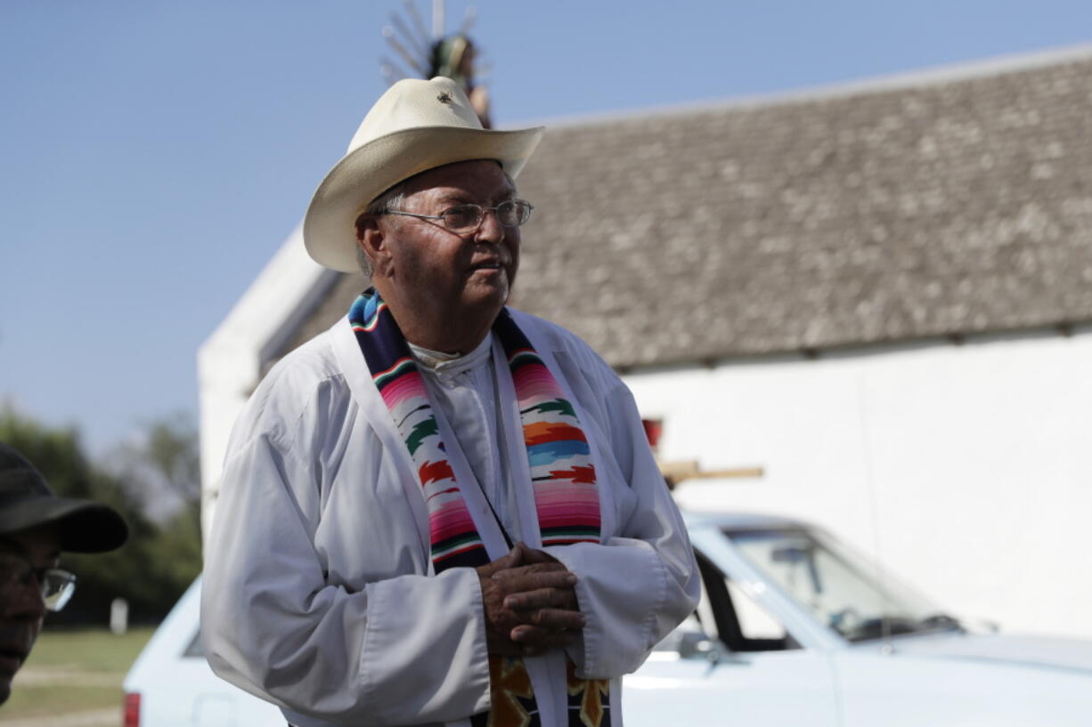 In this Aug. 12, 2017, photo, Father Roy Snipes after he lead a procession to the La Lomita Chapel along a levee toward the Rio Grande to oppose the wall the U.S. government wants to build on the river separating Texas and Mexico in Mission, Texas. Rather than surrender their land to the federal government, some property owners on the Texas border are digging in to fight President Donald Trump’s border wall.