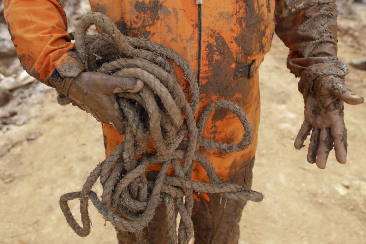 A rescue worker holds rope as he searches for victims Sunday after a dam collapsed in Brumadinho, Brazil.