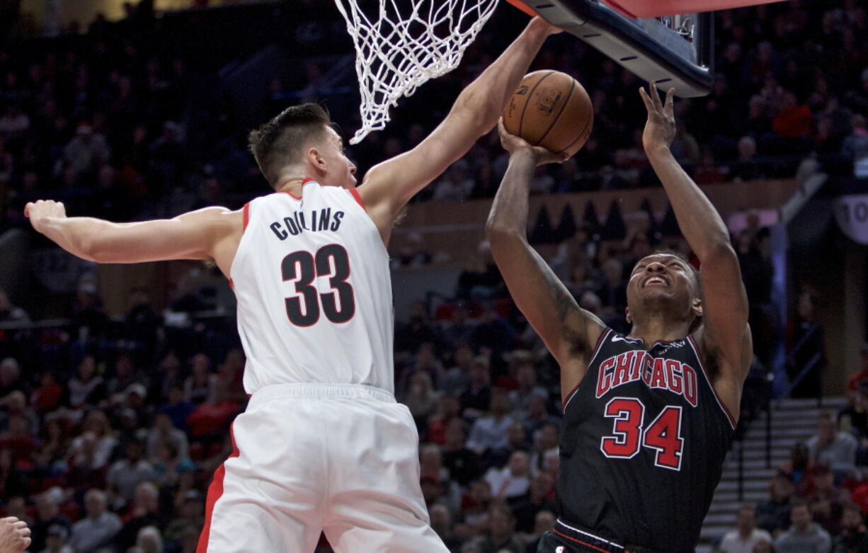 Chicago Bulls forward Wendell Carter Jr., right, shoots over Portland Trail Blazers forward Zach Collins during the second half of an NBA basketball game in Portland, Ore., Wednesday, Jan. 9, 2019.