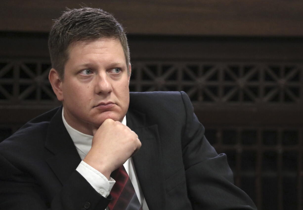 FILE - In this Thursday, Sept. 6, 2018, file photo, Chicago police Officer Jason Van Dyke, charged with first-degree murder in the shooting of black teenager Laquan McDonald in 2014, listens during a hearing at the Leighton Criminal Court Building in Chicago. A judge rejected allegations that the shocking video of McDonald's death proved that police officers staged a cover-up in the fatal shooting of McDonald. Van Dyke was convicted in Oct. 2018 of second-degree murder and aggravated battery, and will likely go to prison for at least several years, if not decades, when he's sentenced Friday, Jan. 18, 2019.