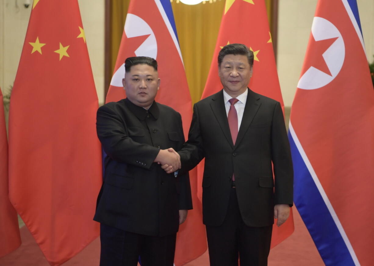 In this Tuesday, Jan. 8, 2019, photo released by China’s Xinhua News Agency, North Korean leader Kim Jong Un, left, and Chinese President Xi Jinping shake hands as they pose for a photo before talks at the Great Hall of the People in Beijing. A special train believed to be carrying Kim Jong Un departed Beijing on Wednesday after a two-day visit by the North Korean leader to the Chinese capital.