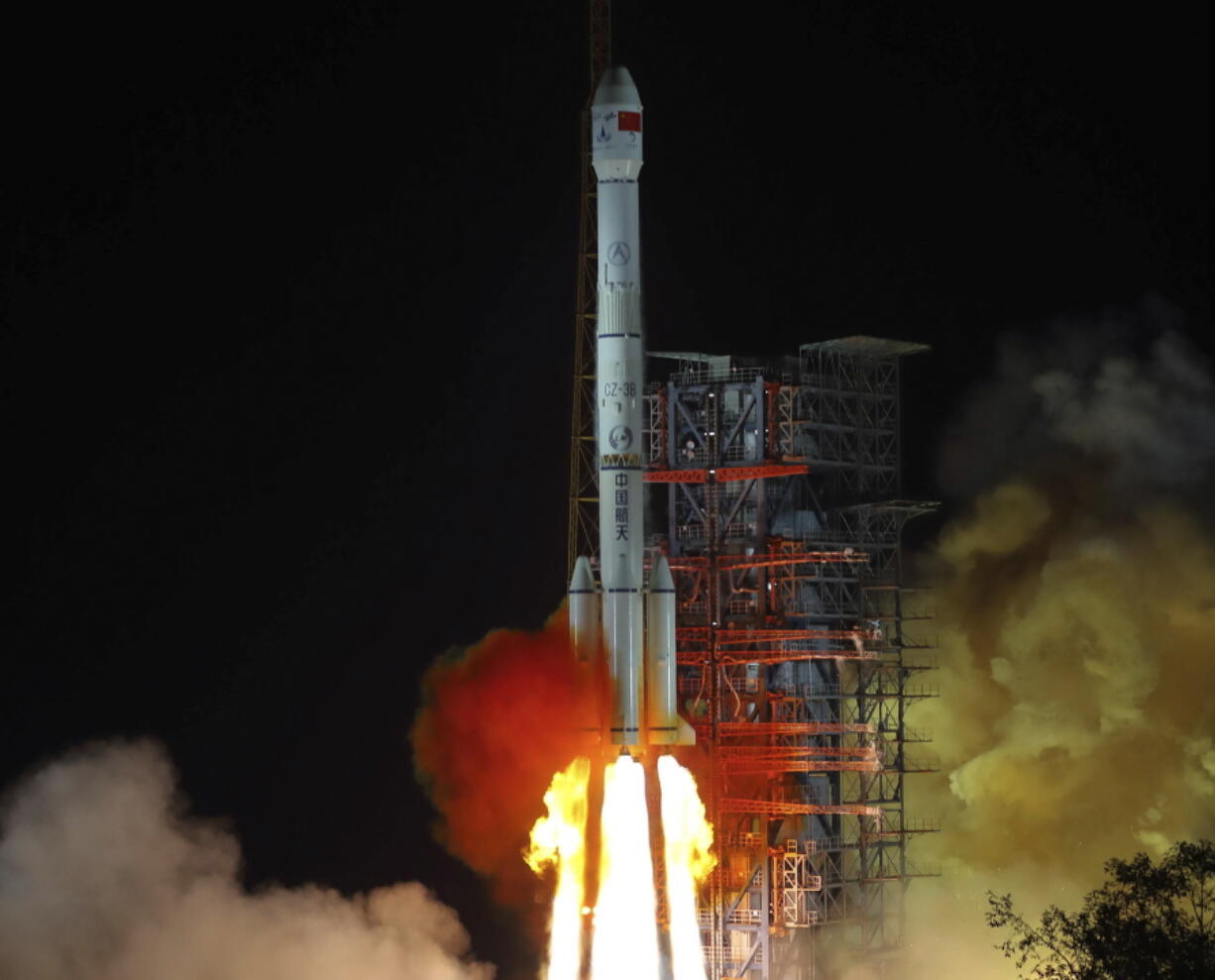 In this Dec. 8 photo, released by Xinhua News Agency, the Chang'e 4 lunar probe launches from the the Xichang Satellite Launch Center in southwestern China's Sichuan province. The official China Central Television says Thursday the lunar explorer Chang'e 4 had touched down at 10:26 a.m to make first-ever landing on the far side of the moon.