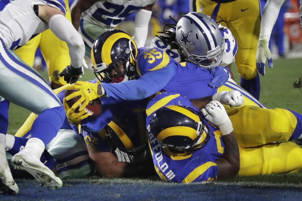 Los Angeles Rams running back C.J. Anderson scores against the Dallas Cowboys during the first half in an NFL divisional football playoff game Saturday, Jan. 12, 2019, in Los Angeles.