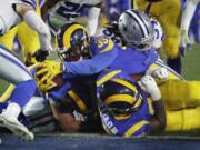 Los Angeles Rams running back C.J. Anderson scores against the Dallas Cowboys during the first half in an NFL divisional football playoff game Saturday, Jan. 12, 2019, in Los Angeles.