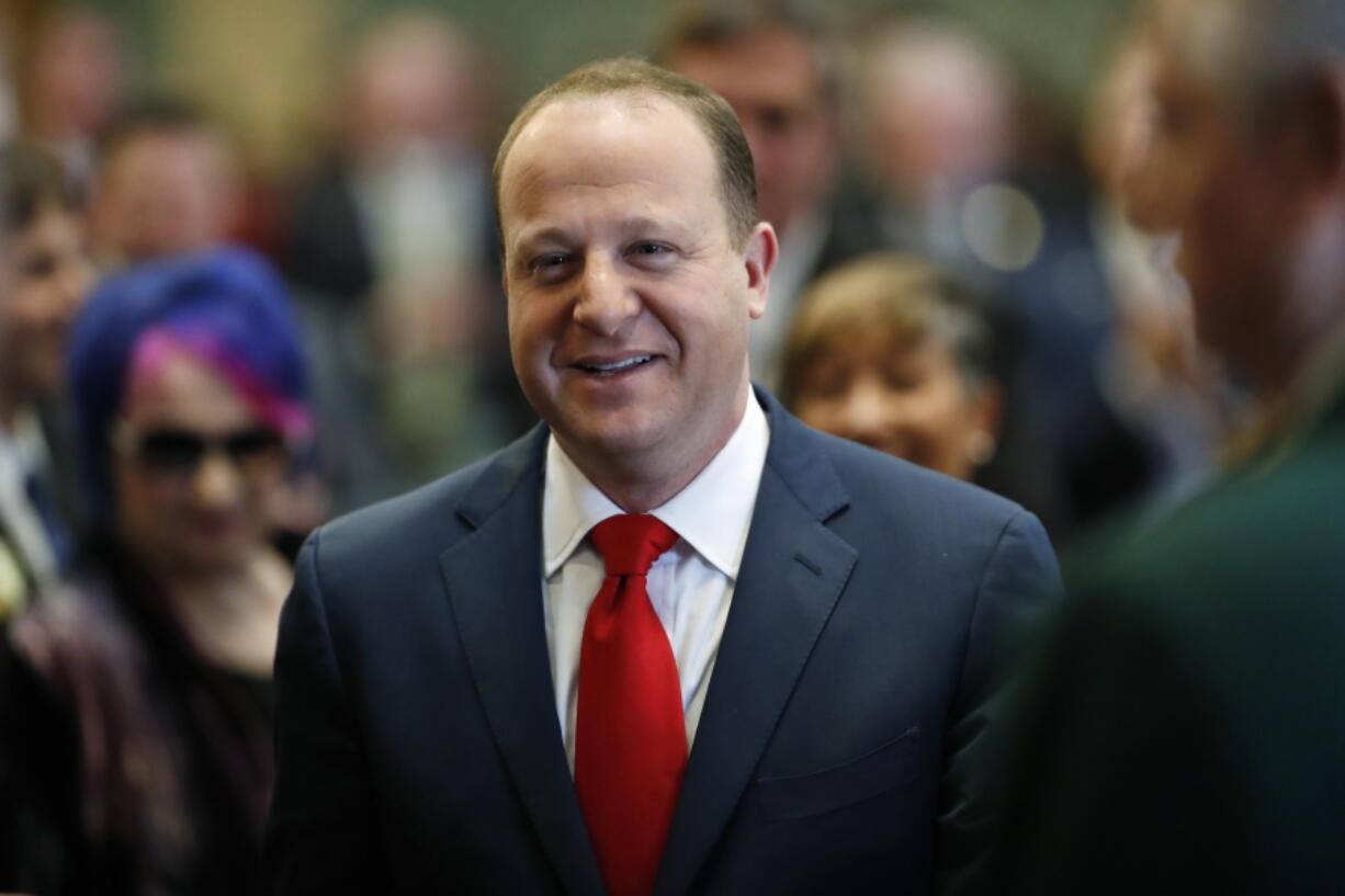 FILE - In this Jan. 10, 2019 file photo, Colorado Governor Jared Polis enters the House of Representatives chamber to make his first State of the State address to a joint session of the Colorado Legislature in Denver. Polis said Wednesday, Jan. 23, he is seeking to prevent Denver teachers from walking off the job next week after they overwhelmingly voted to strike over pay.