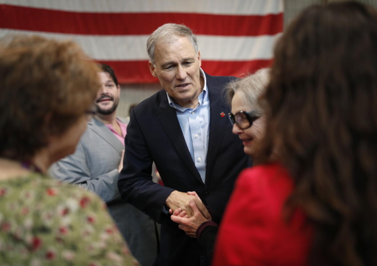 Washington Gov. Jay Inslee meets with people after speaking at the Battle Born Progress Progressive Summit, Saturday, Jan. 12, 2019, in North Las Vegas, Nev. Inslee pitched his record tackling climate change, gun control measures, raising the minimum wage and expanding paid family leave to Nevada progressive activists in the early presidential nominating state.