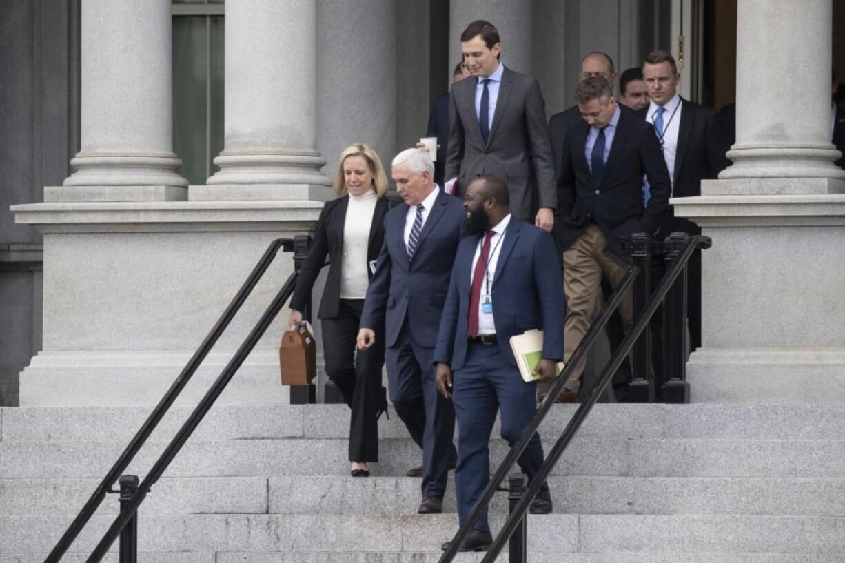 Homeland Security Secretary Kirstjen Nielsen, left, Vice President Mike Pence, White House legislative affairs aide Ja'Ron Smith, followed by White House Senior Adviser Jared Kushner, and others, walk down the steps of the Eisenhower Executive Office building, on the White House complex, after a meeting with staff members of House and Senate leadership, Saturday, Jan. 5, 2019, in Washington.