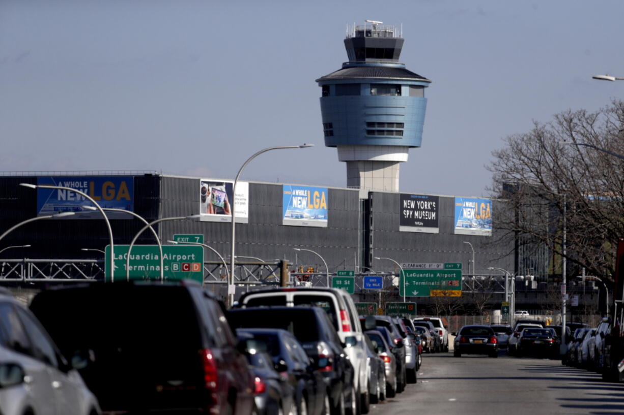 The air traffic control tower at LaGuardia Airport is seen, Friday, Jan. 25, 2019, in New York. The Federal Aviation Administration reported delays in air travel Friday because of a “slight increase in sick leave” at two East Coast air traffic control facilities.