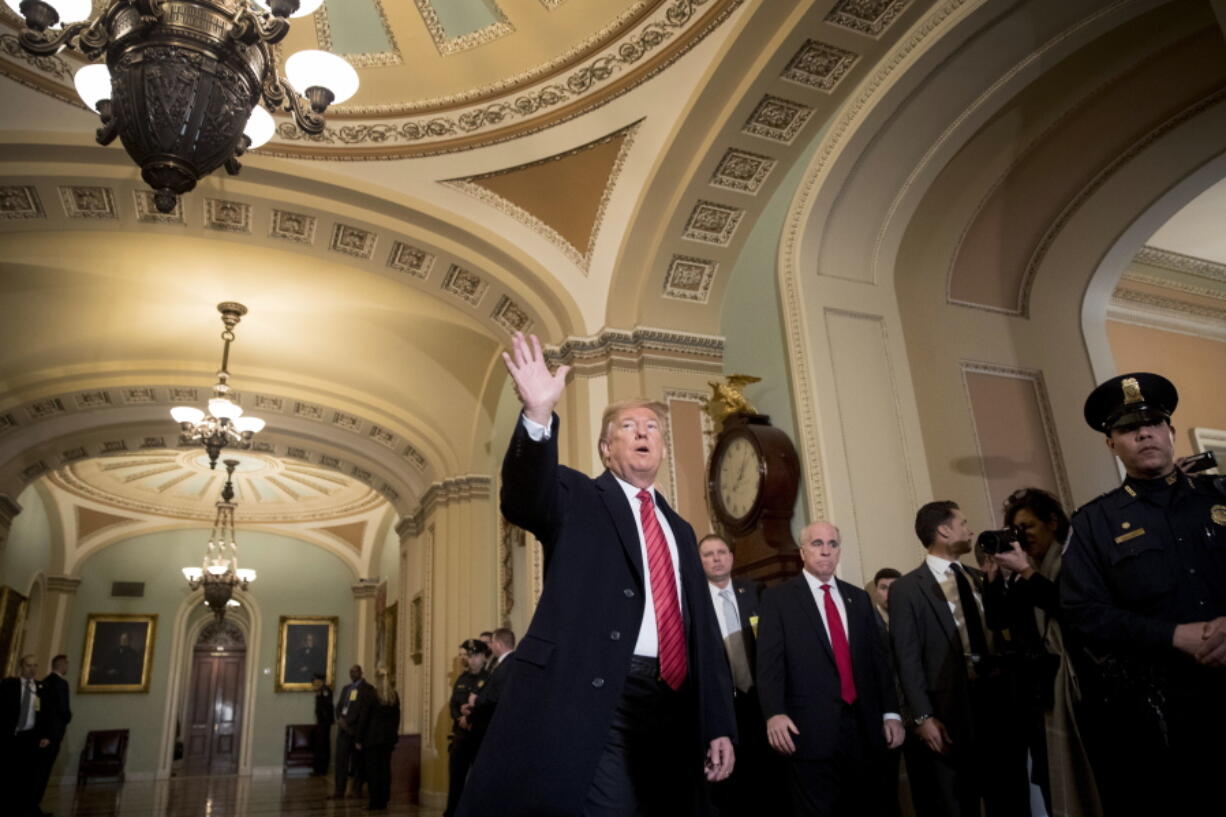 President Donald Trump, accompanied by Vice President Mike Pence, waves to members of the media as he arrives for a Senate Republican Policy lunch on Capitol Hill in Washington, Wednesday, Jan. 9, 2019.