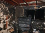 Vancouver firefighters were able to extinguish a blaze overnight Friday at an apartment building in the Fourth Plain Village neighborhood caused by a candle and discarded smoking materials. The city's fire marshal said it caused $143,300 in damages.