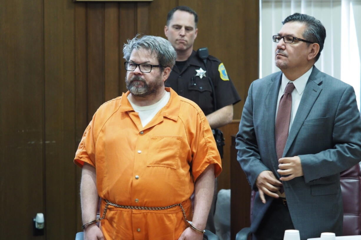 FILE - In this April 20, 2017 file photo, defendant Jason Dalton, left, who is charged with killing six people in-between picking up riders for Uber, stands with attorney Eusebio Solis during a hearing in Kalamazoo, Mich. Jury selection will begin on Jan. 3, 2019 after a prosecutor said he won’t appeal a decision that keeps a lid on parts of a police interview. Kalamazoo County prosecutor Jeff Getting says it’s time to bring the “matter to trial without further delay.” The shootings occurred more than two years ago.