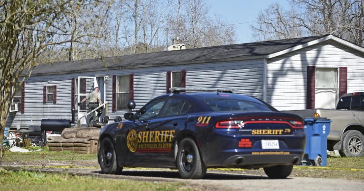 Investigators work the scene of a shooting on Saturday, Jan. 26, 2019, in Ascension Parish in Louisiana. Authorities in Louisiana say a shooting has left five people dead in two parishes. A suspect was at large and was being sought. Officials say the Saturday morning shootings happened in Ascension and Livingston parishes, about 70 miles west of New Orleans. Dakota Theriot was being sought by authorities.