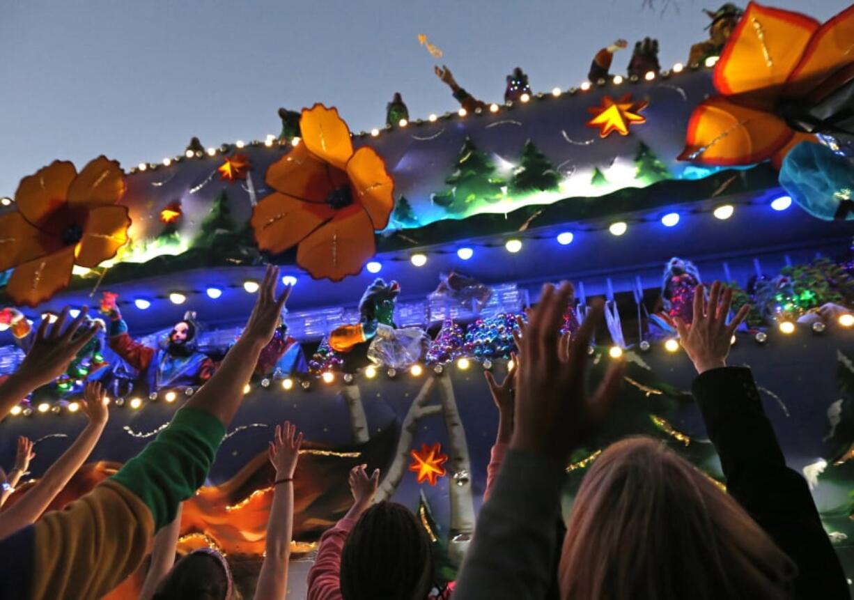 FILE - In this Feb. 25, 2017 file photo, revelers scream for beads during the Krewe of Endymion Mardi Gras parade in New Orleans. The rest of America may be winding down from Christmas and New Year’s. But in New Orleans, another party is about to get started. Mardi Gras season kicks off Sunday, Jan. 6, 2019.