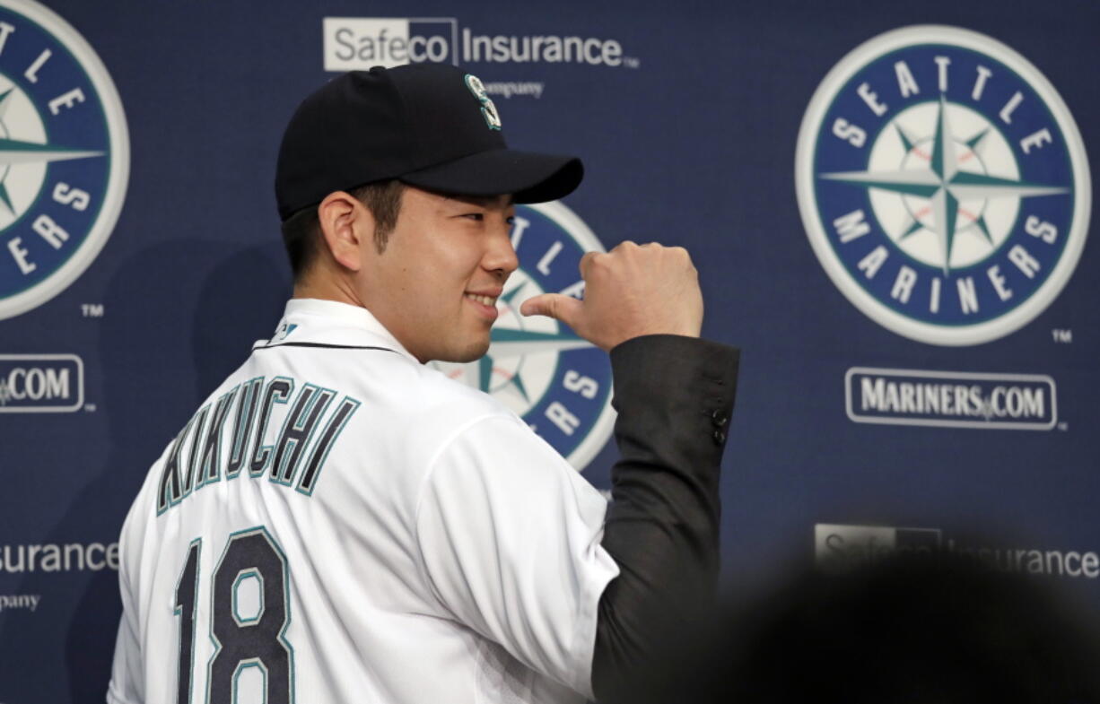 Seattle Mariners pitcher Yusei Kikuchi smiles and shows off his new jersey following a news conference after his signing with the team, Thursday, Jan. 3, 2019, in Seattle. Kikuchi is the latest Japanese star to decide on calling Seattle home in the majors. The Mariners hope their new left-handed pitcher can help in their rebuild process.