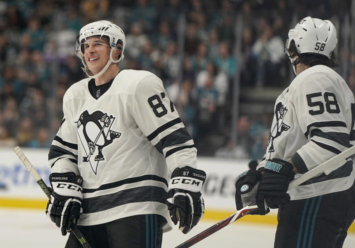 Metropolitan Division’s Sidney Crosby, left, smiles next to Kris Letang, both of the Pittsburgh Penguins. Crosby was selected the MVP of NHL All-Star Game in San Jose.