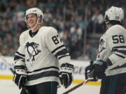 Metropolitan Division’s Sidney Crosby, left, smiles next to Kris Letang, both of the Pittsburgh Penguins. Crosby was selected the MVP of NHL All-Star Game in San Jose.