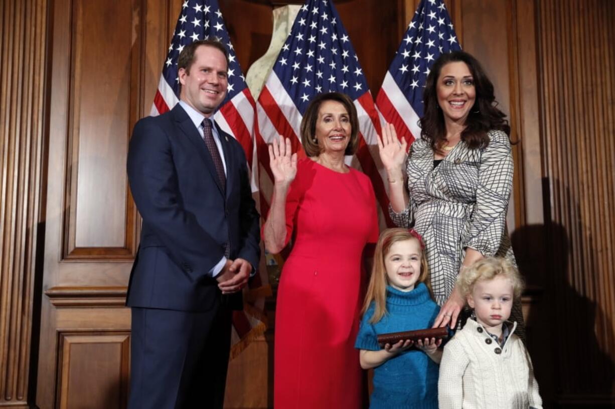 House Speaker Nancy Pelosi of Calif., left, poses during a ceremonial swearing-in with Rep. Jaime Herrera Beutler, R-Battle Ground, right, on Capitol Hill, Thursday, Jan. 3, 2019 in Washington during the opening session of the 116th Congress.