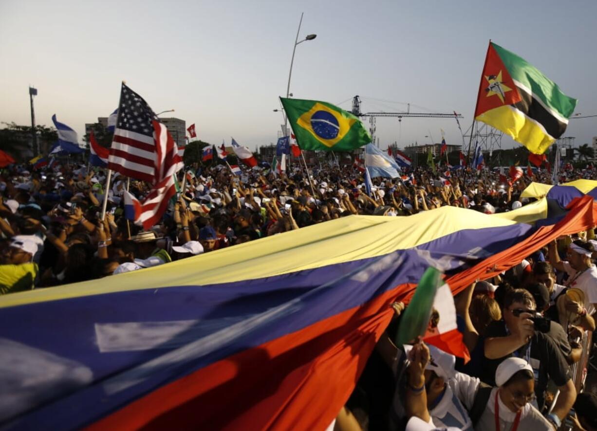 Thousands of pilgrims wave their national flags as Pope Francis arrives for a welcoming ceremony to open his participation in the church’s World Youth Day festivities in Panama City, Thursday, Jan. 24, 2019.