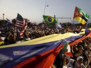 Thousands of pilgrims wave their national flags as Pope Francis arrives for a welcoming ceremony to open his participation in the church’s World Youth Day festivities in Panama City, Thursday, Jan. 24, 2019.