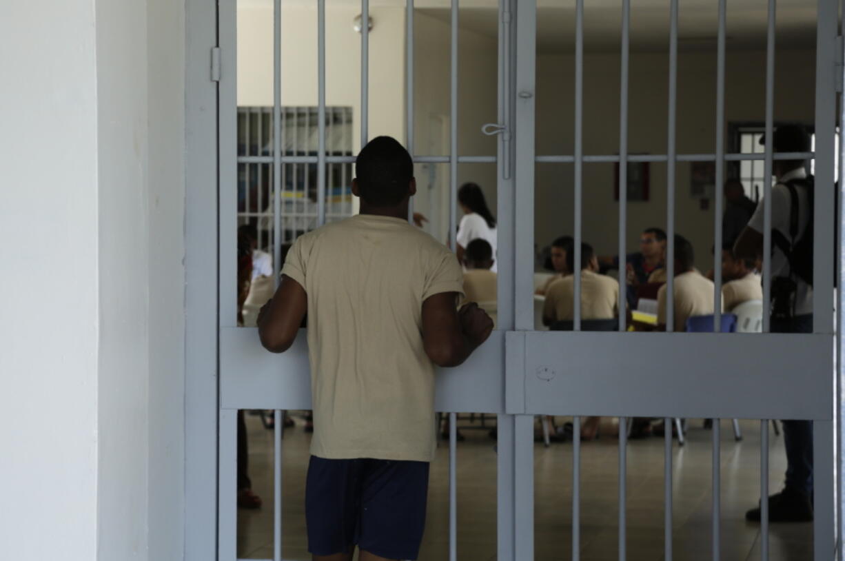 A young inmates looks at another group of fellow inmates during choir practice at the Las Garzas de Pacora detention center, Panama, Wednesday, Jan. 16, 2019. Pope Francis nearly always makes side visits to prisons during his foreign trips, in keeping with his belief that even those on the lowest rungs of society have dignity and need ministry.