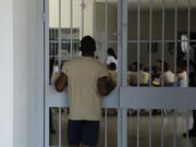 A young inmates looks at another group of fellow inmates during choir practice at the Las Garzas de Pacora detention center, Panama, Wednesday, Jan. 16, 2019. Pope Francis nearly always makes side visits to prisons during his foreign trips, in keeping with his belief that even those on the lowest rungs of society have dignity and need ministry.