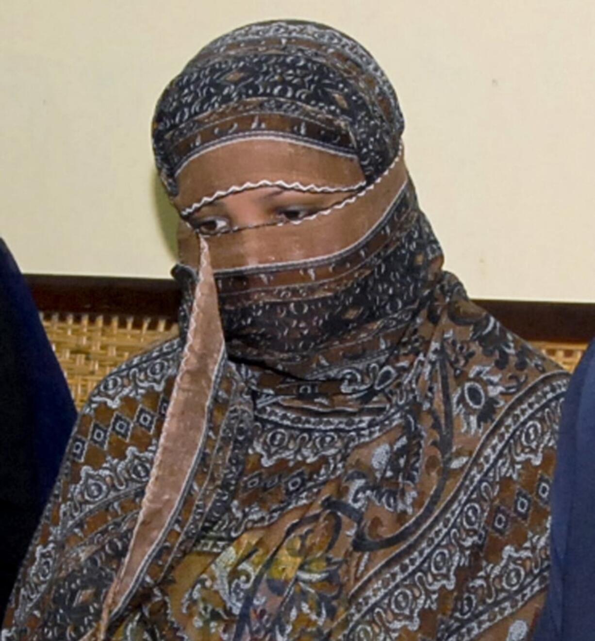 FILE - In this Nov. 20, 2010 file photo, Aasia Bibi, a Pakistani Christian woman, listens to officials at a prison in Sheikhupura near Lahore, Pakistan. Pakistan’s top court on Tuesday upheld its acquittal of Bibi, who had been sentenced to death for blasphemy, clearing the last legal hurdle and freeing her to leave the country in a move that dealt a blow to radical Islamists who had demanded her execution.