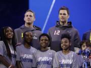 New England Patriots’ Tom Brady and Los Angeles Rams’ Jared Goff pose for a picture during Opening Night for the NFL Super Bowl 53 football game Monday, Jan. 28, 2019, in Atlanta.