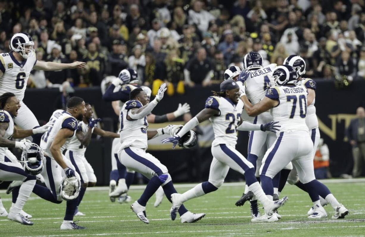 Los Angeles Rams players celebrate after overtime of the NFL football NFC championship game against the New Orleans Saints, Sunday, Jan. 20, 2019, in New Orleans. (AP Photo/David J.