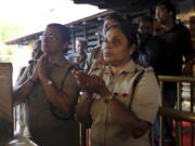 FILE - In this Nov. 5, 2018 file photo, police officers, who are above the age of 50, pray at the Sabarimala temple, one of the world’s largest Hindu pilgrimage sites, in the southern Indian state of Kerala. The historic temple had barred women age 10 to 50 from entering the temple.