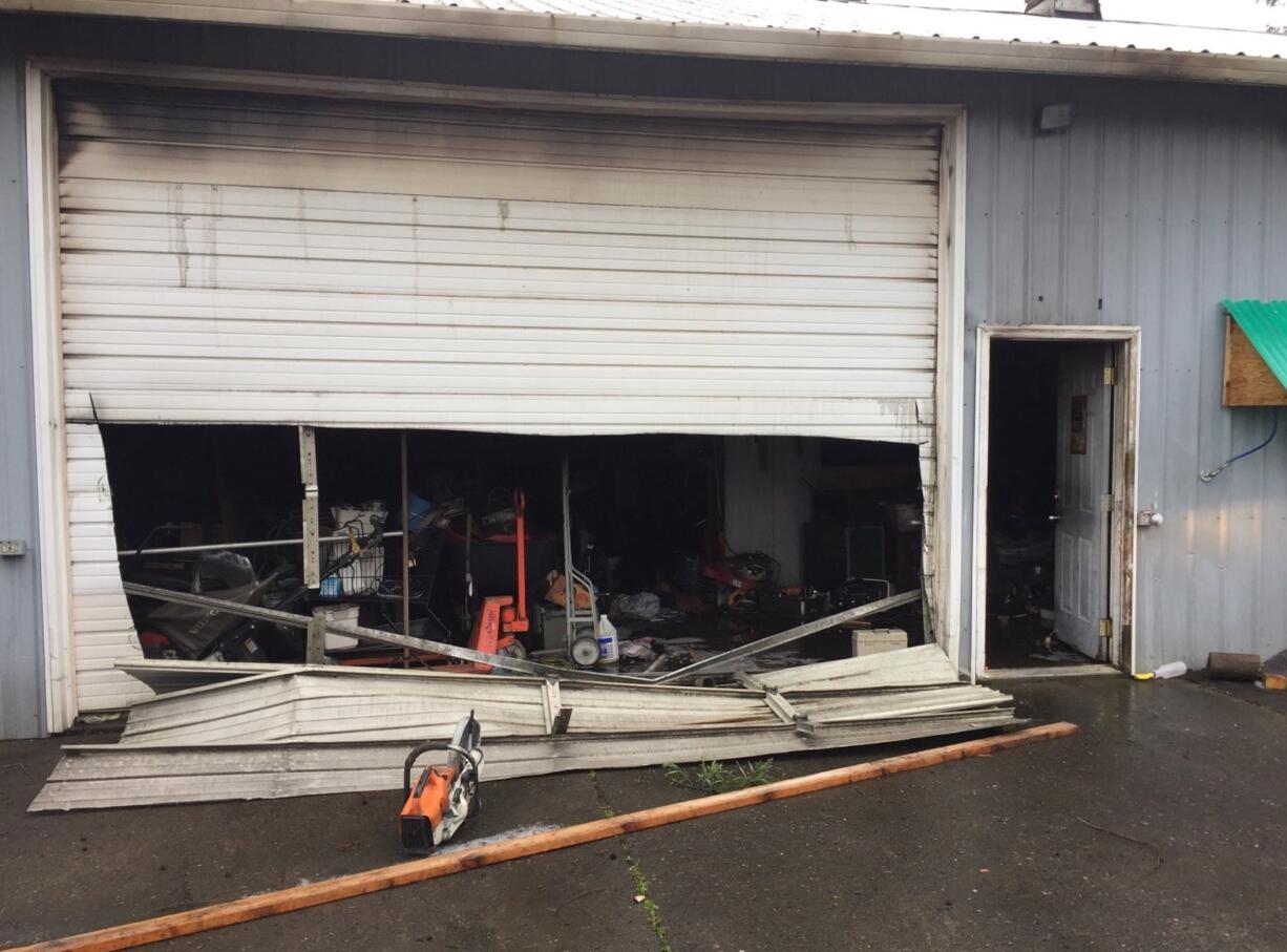 Clark County Fire & Rescue firefighters cut a hole into the front of this structure in Ridgefield in an attempt to get closer to the fire, but contents inside prevented them from doing so. They cut a second hole into the side of the building, entered and extinguished the fire.