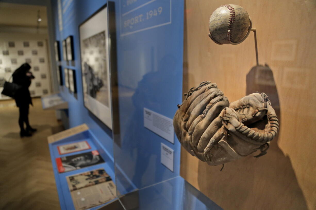 In this Tuesday, Jan. 29, 2019 photo, a glove used by Brooklyn Dodgers baseball player Jackie Robinson is displayed at the exhibit “In the Dugout with Jackie Robinson: An Intimate Portrait of a Baseball Legend” at the Museum of City of New York in New York. The 100th anniversary of Robinson’s birth is celebrated Thursday, Jan. 31, with the opening of the exhibit.