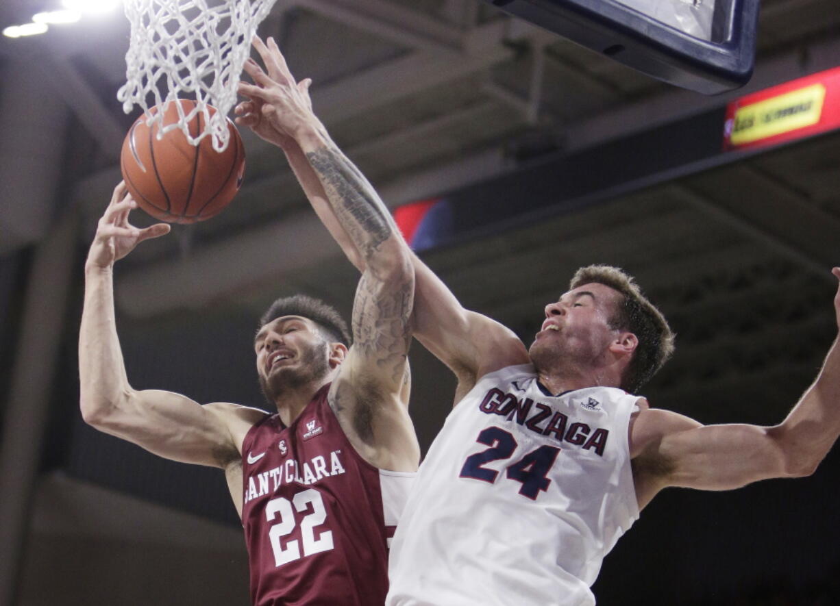 Santa Clara forward Josh Martin (22) and Gonzaga forward Corey Kispert (24) go after a rebound during the first half of an NCAA college basketball game in Spokane, Wash., Saturday, Jan. 5, 2019.