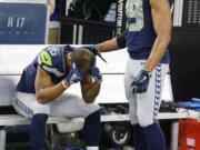 Seattle Seahawks wide receiver Tyler Lockett (16) is consoled by Doug Baldwin (89) after their NFC wild-card NFL football game against the Dallas Cowboys in Arlington, Texas, Saturday, Jan. 5, 2019. The Cowboys won 24-22.