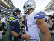 Seattle Seahawks quarterback Russell Wilson, left, greets Dallas Cowboys quarterback Dak Prescott, right, following their game on Sept. 23, 2018 in Seattle.