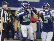 Seattle Seahawks’ K.J. Wright (50) and Bobby Wagner (54) celebrate an interception against Dallas Cowboys quarterback Dak Prescott during the second half of the NFC wild-card NFL football game in Arlington, Texas, Saturday, Jan. 5, 2019.