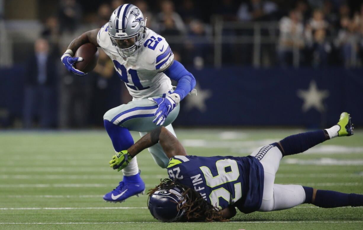 Dallas Cowboys running back Ezekiel Elliott (21) runs near Seattle Seahawks cornerback Shaquill Griffin (26) during the second half of the NFC wild-card NFL football game in Arlington, Texas, Saturday, Jan. 5, 2019.